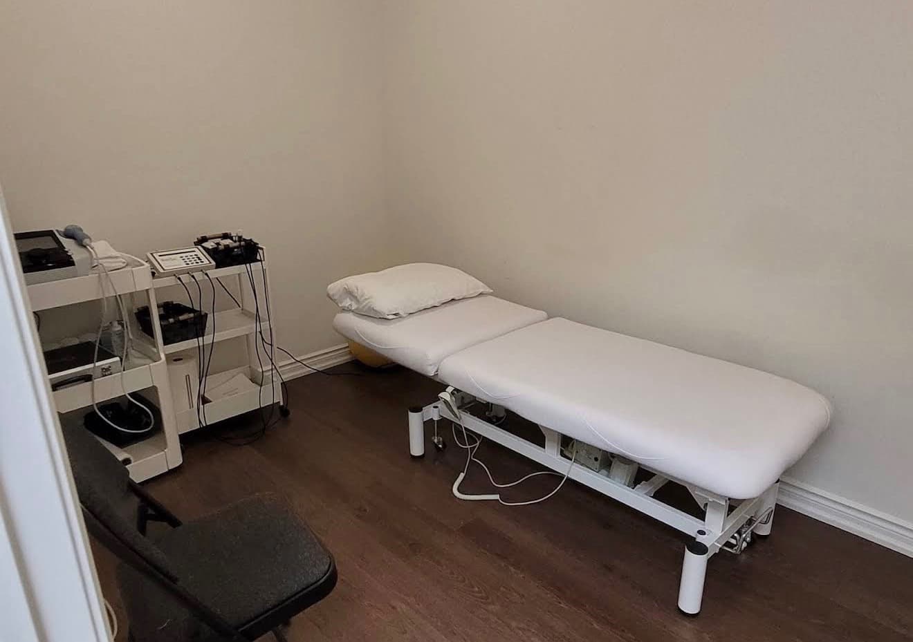 Treatment room with desk and exam table